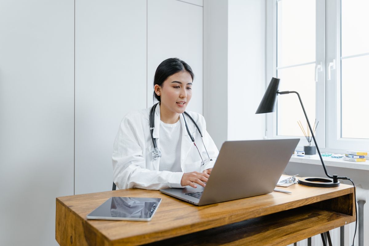 Researcher at a microscope in warm laboratory light